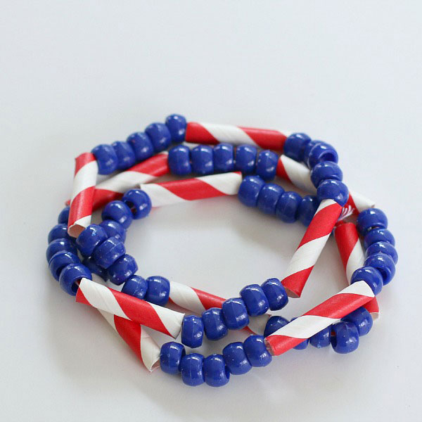 4th of July bracelet craft made from blue beads and red and white straw pieces