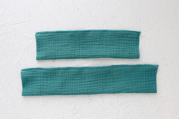 Rectangle pieces folded in half lengthwise and sewn on long raw edge.