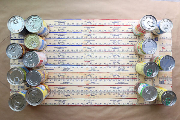 Four half yardsticks glued across the back of the other yardsticks; weighed down with cans.