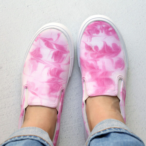 Marble tie dyed shoes on feet.