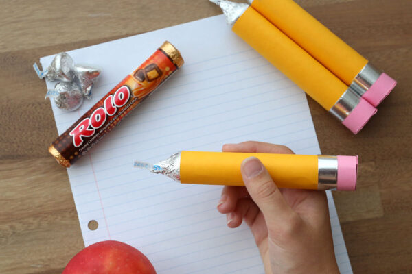 Hand holding a Rolo pencil.