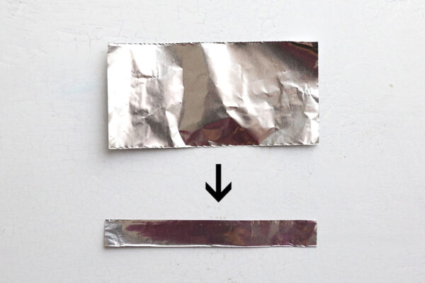 Piece of foil folded in half lengthwise twice.