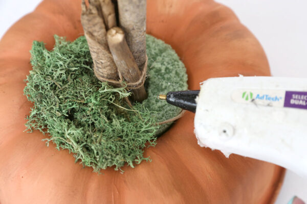 Gluing moss to cover the floral foam.