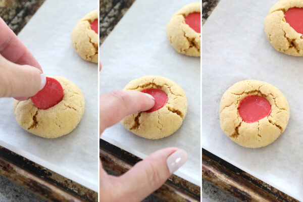 Pressing a red candy melt into the peanut butter cookie.