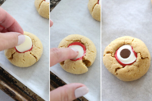 Pressing a white candy melt into the red candy; adding a chocolate chip.