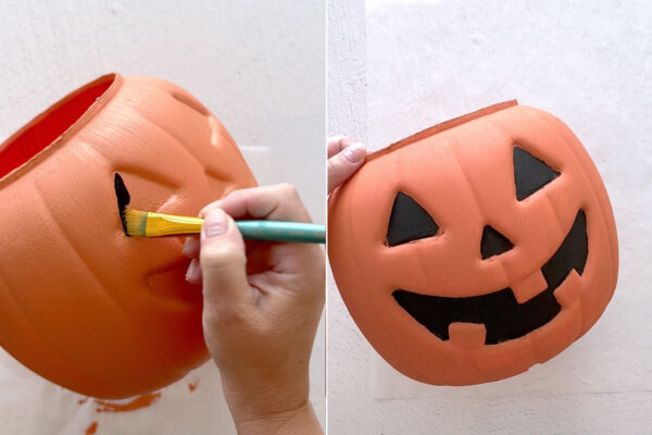 Using a small paintbrush to paint the eyes, nose, and mouth black.